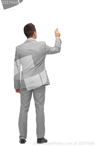 Image of businessman writing or drawing something imaginary