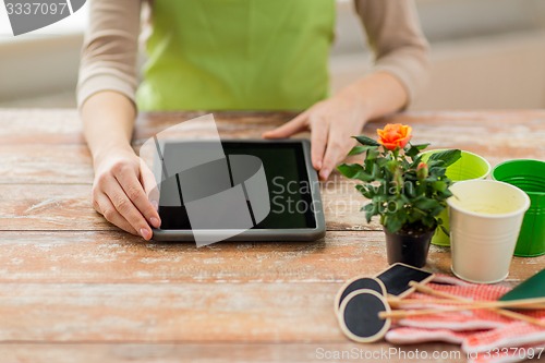 Image of close up of woman or gardener with tablet pc