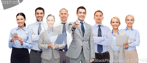 Image of group of happy business people pointing at you