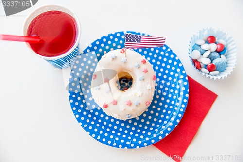 Image of donut with juice and candies on independence day