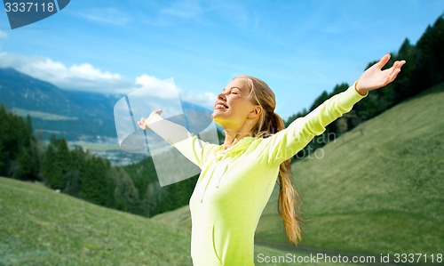 Image of happy woman in sportswear enjoying sun and freedom