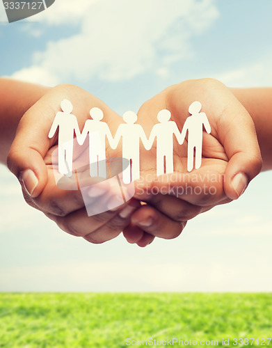 Image of womans hands with paper team