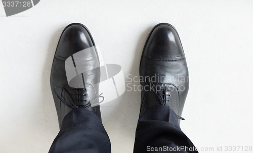 Image of close up of man legs in elegant shoes with laces