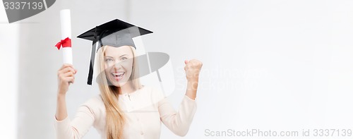 Image of student in graduation cap with certificate