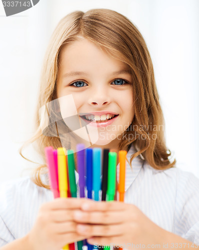 Image of girl showing colorful felt-tip pens