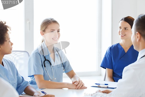 Image of group of happy doctors meeting at hospital office