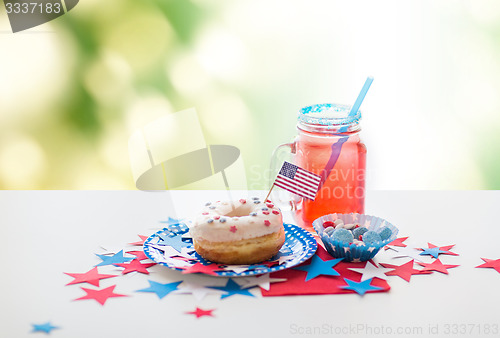 Image of donut with juice and candies on independence day