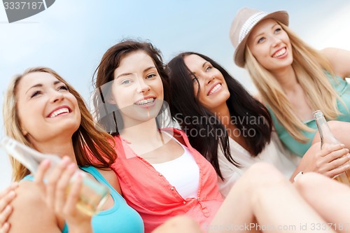 Image of girls with drinks on the beach