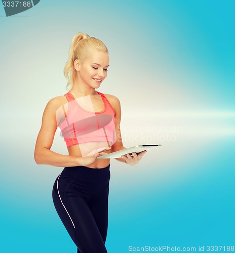 Image of smiling sporty woman with tablet pc computer