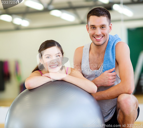Image of two smiling people with fitness ball