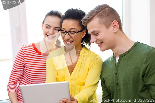 Image of smiling students with tablet pc at school