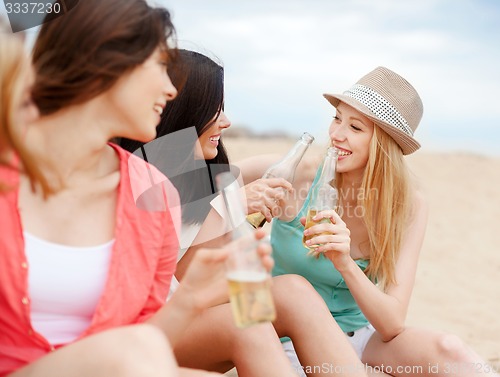 Image of girls with drinks on the beach