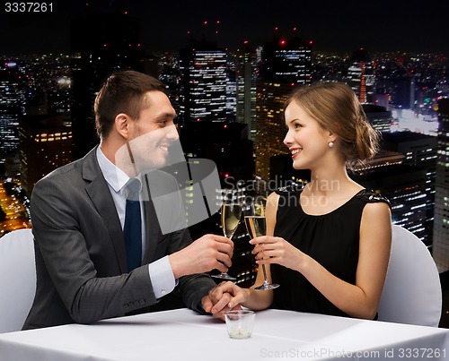 Image of couple with glasses of champagne at restaurant