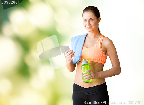 Image of happy woman with smartphone and bottle of water