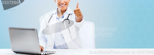 Image of female doctor with laptop pc showing thumbs up