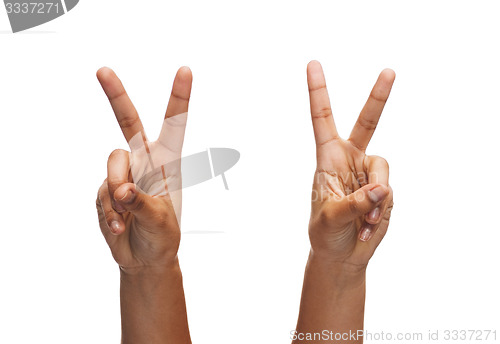 Image of woman hands showing v-sign