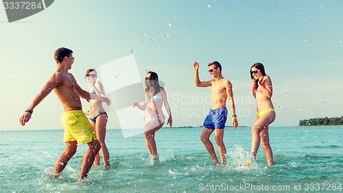 Image of happy friends having fun on summer beach