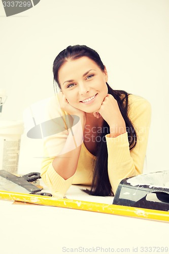 Image of lovely housewife making repairing works