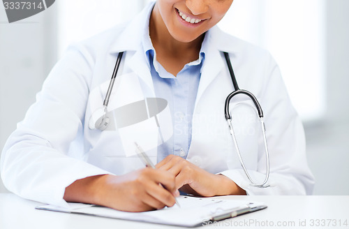 Image of female doctor writing prescription