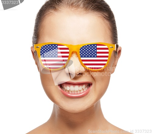 Image of happy teenage girl in shades with american flag