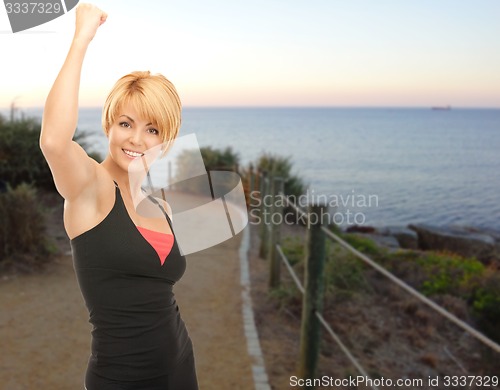 Image of happy woman jogging outdoors over beach background