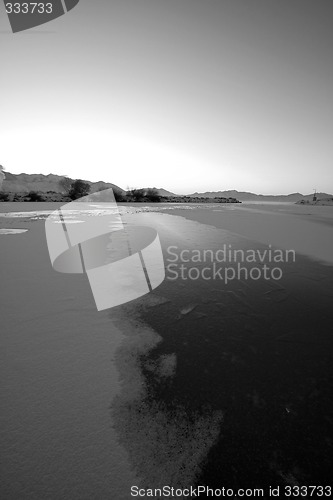 Image of Sunrise over the Frozen Lake in Black and White