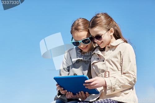 Image of happy girls with tablet pc computer outdoors