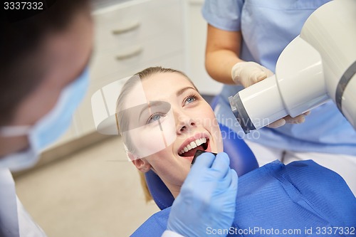 Image of female patient face with x-ray machine and shield