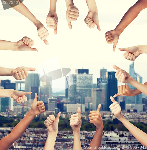 Image of human hands showing thumbs up in circle