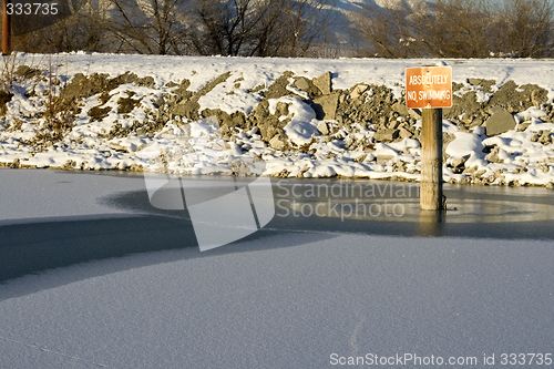 Image of No Swimming Sign on the Frozen Lake