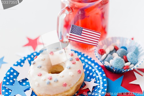 Image of donut with juice and candies on independence day