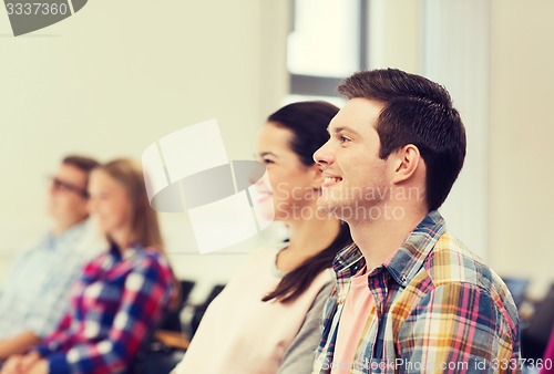 Image of group of smiling students in lecture hall