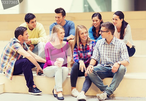 Image of group of smiling students with paper coffee cups