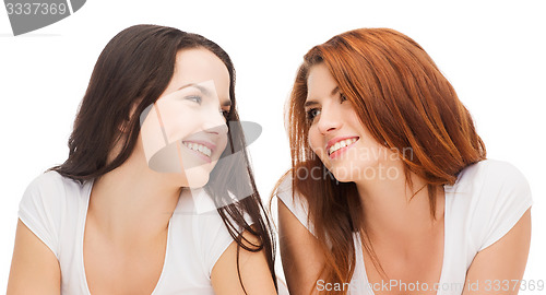 Image of two laughing girls in white t-shirts