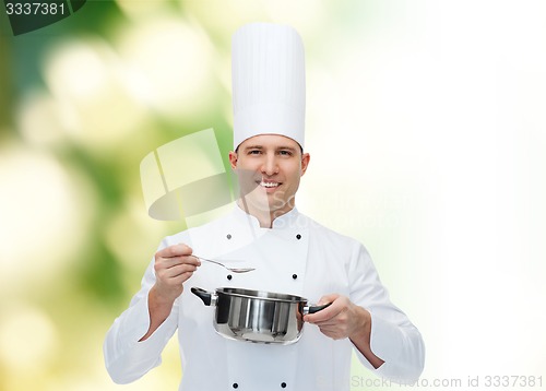 Image of happy male chef cook with pot and spoon