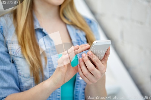 Image of close up of female hands with smartphone