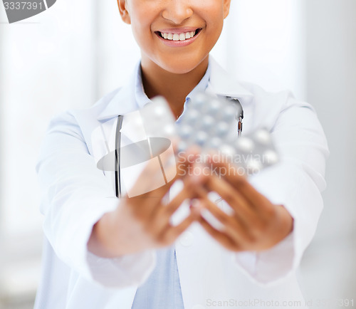 Image of doctor with blister packs of pills