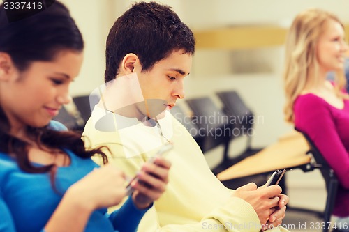 Image of group of smiling students in lecture hall
