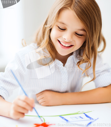 Image of little girl painting at school