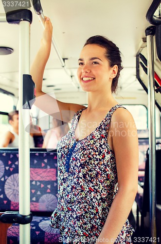 Image of smiling teenage girl going by bus