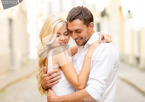 Image of romantic happy couple hugging in the street