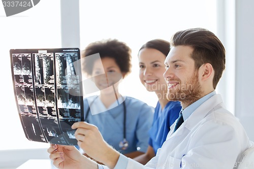 Image of group of happy doctors discussing x-ray image