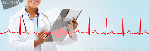 Image of close up of smiling female doctor with clipboard