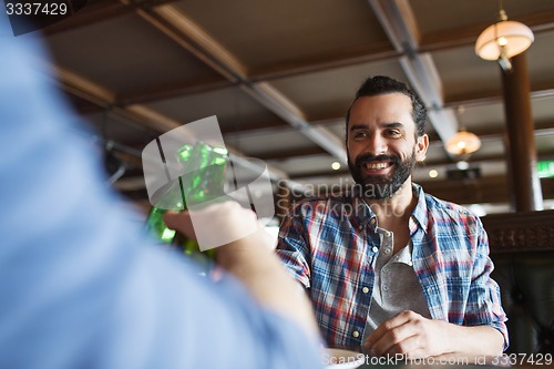 Image of happy male friends drinking beer at bar or pub