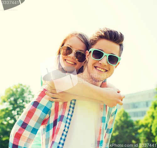 Image of smiling couple having fun in park