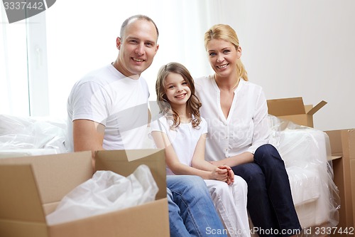 Image of happy family with boxes moving to new home