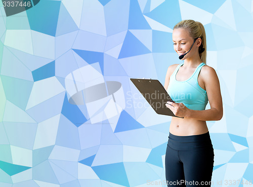 Image of happy woman trainer with microphone and clipboard