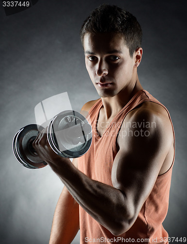 Image of young man with dumbbell