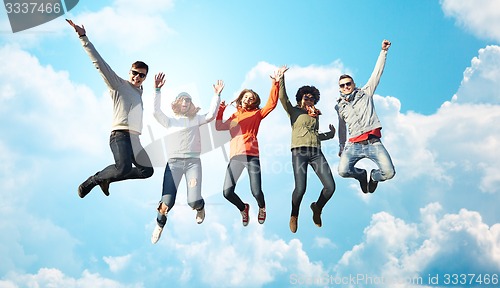 Image of smiling friends in sunglasses jumping high