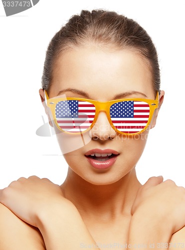 Image of happy teenage girl in shades with american flag